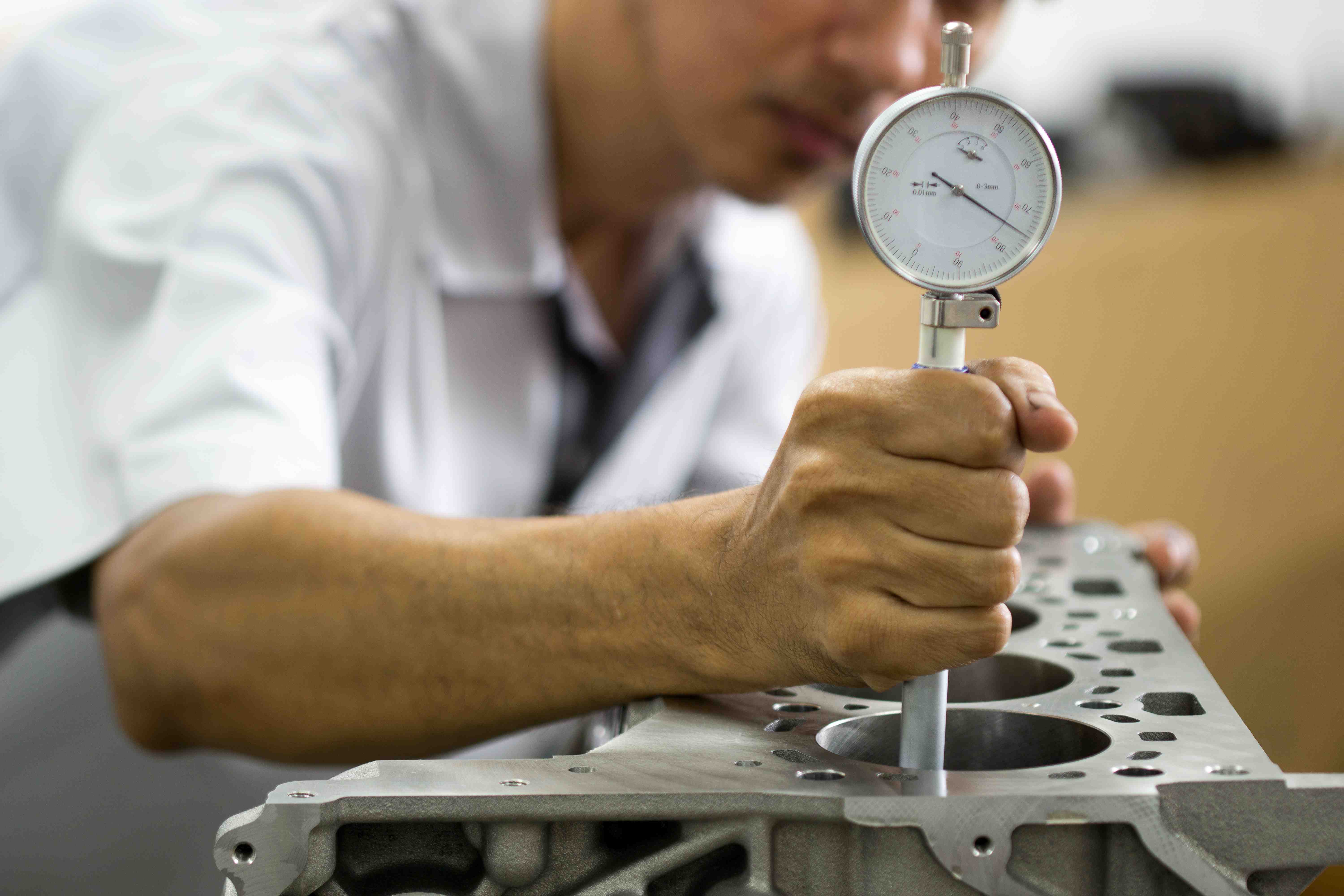 Hand mechanic using Bore gauge (Measurement Tool) Checking cylinder in Engine block .Repair car in workshop