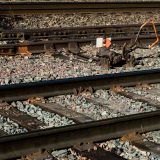 Railroad tracks with a rusty switch and gravel